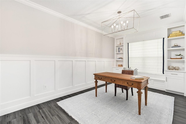 home office with built in shelves, dark hardwood / wood-style floors, crown molding, and an inviting chandelier