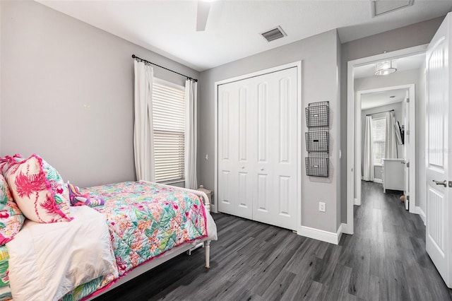 bedroom with a closet, ceiling fan, and dark hardwood / wood-style floors