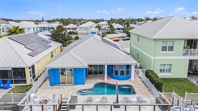 6408 Key Island Ave, Apollo Beach, FL 33572 - rear view of house with a fenced in pool, a fenced backyard, a residential view, a patio, and an outdoor fire pit