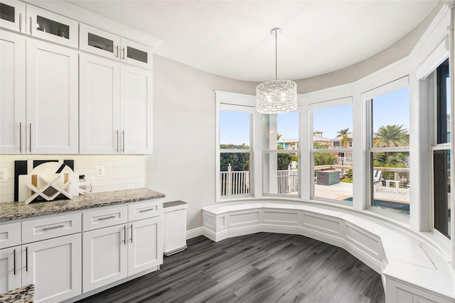 6408 Key Island Ave, Apollo Beach, FL 33572 - unfurnished dining area featuring a notable chandelier and dark wood-style floors
