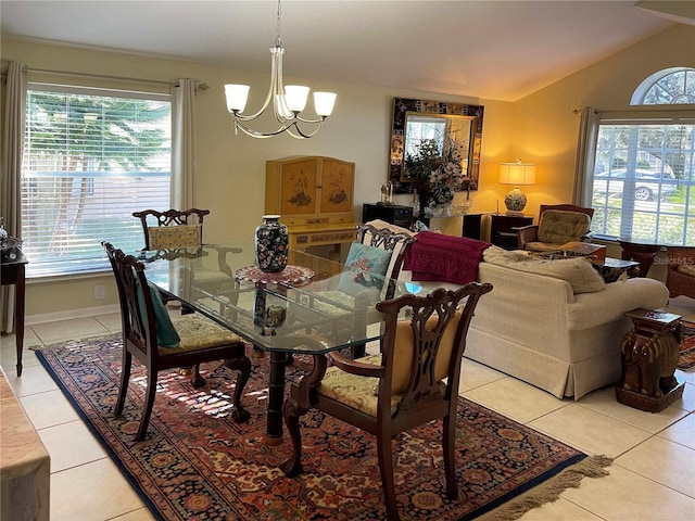 tiled dining area with a chandelier and vaulted ceiling