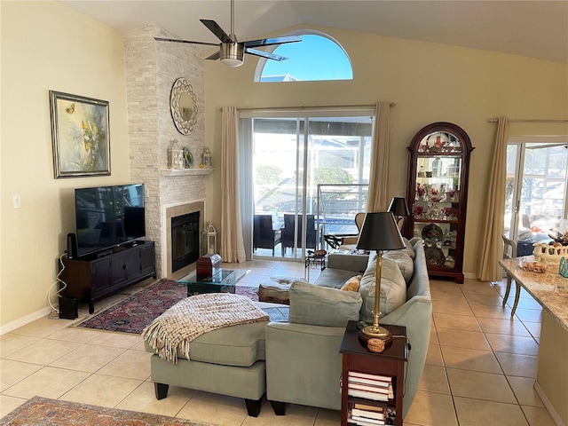 tiled living room featuring ceiling fan, a fireplace, and vaulted ceiling