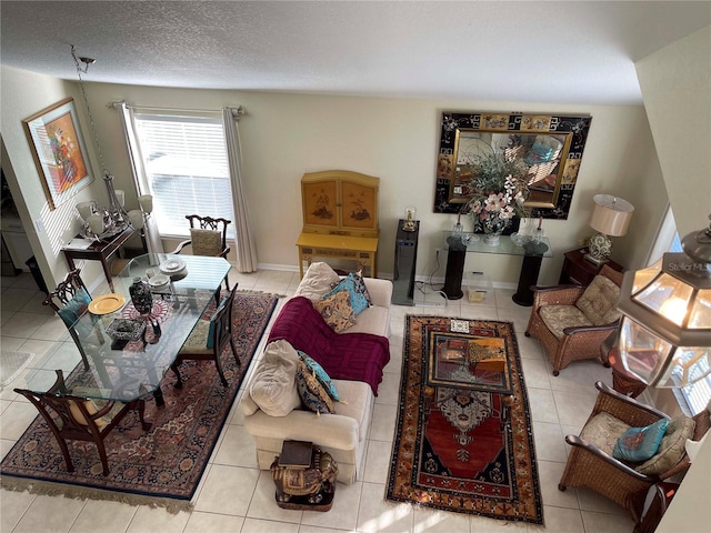 tiled living room featuring a textured ceiling