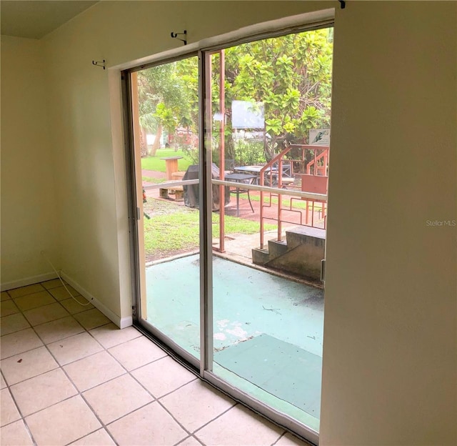 doorway with light tile patterned flooring