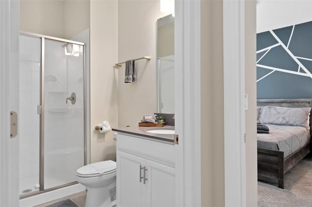 bathroom with vanity, toilet, and an enclosed shower