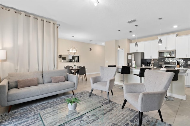 tiled living room featuring a chandelier