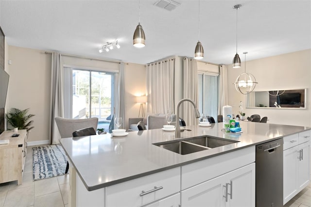 kitchen with dishwasher, sink, an island with sink, and hanging light fixtures