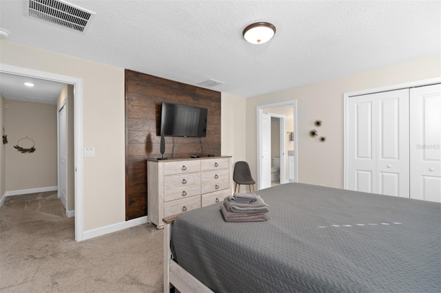 carpeted bedroom with a textured ceiling and a closet