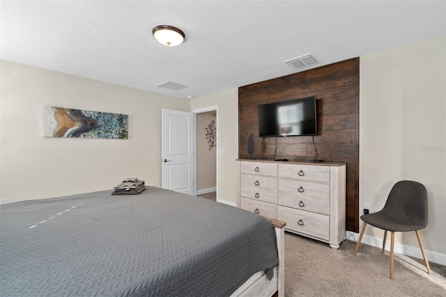 carpeted bedroom with a textured ceiling