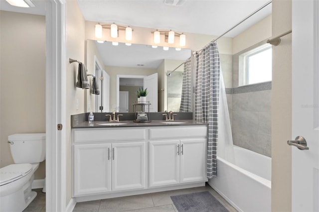 full bathroom featuring tile patterned flooring, vanity, shower / tub combo with curtain, and toilet