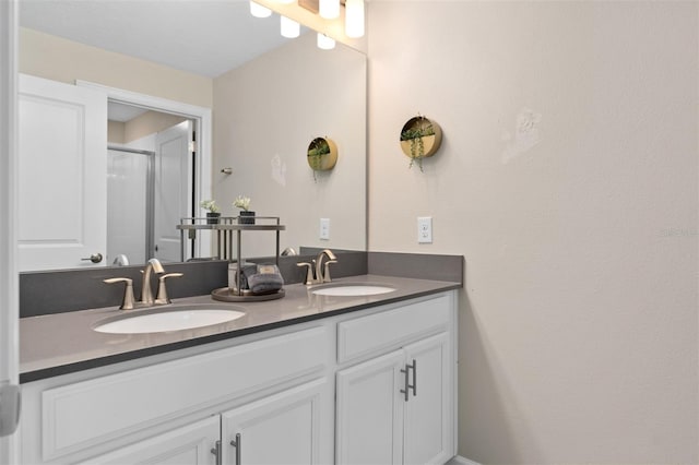 bathroom with vanity and a shower with door