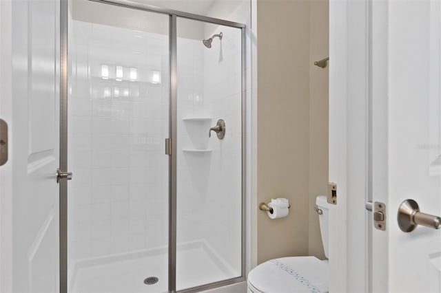 bathroom with toilet and walk in shower