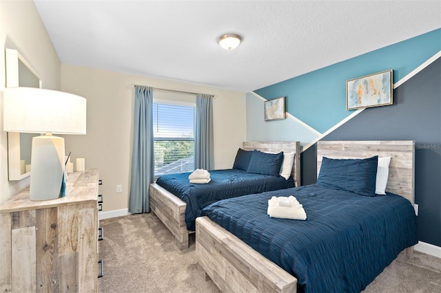 bedroom with a textured ceiling and light carpet