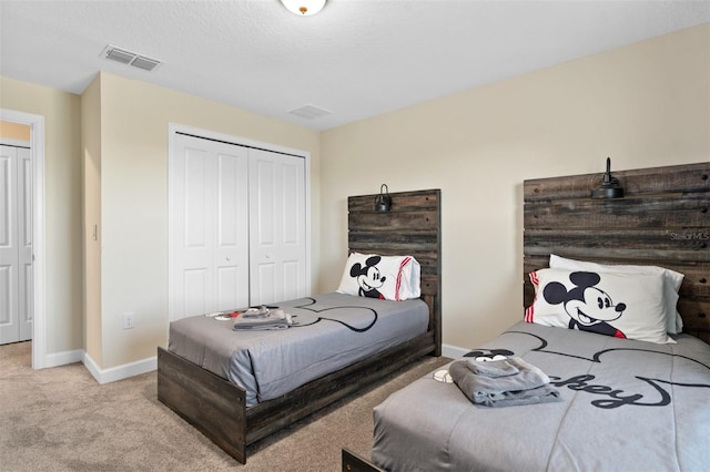 bedroom with light carpet and a closet