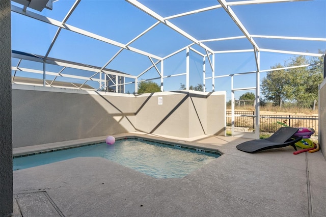 view of pool with a patio area and a lanai