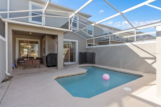 view of swimming pool featuring a lanai and a patio