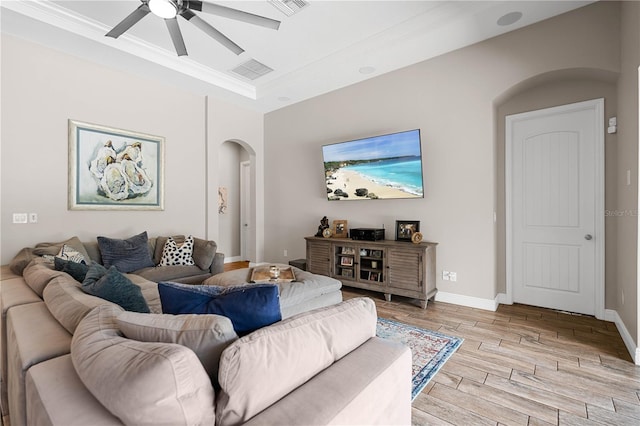 living room featuring ceiling fan and crown molding