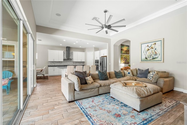 living room featuring ceiling fan and sink