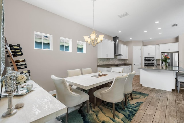 dining room featuring a notable chandelier and sink