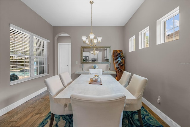 dining area featuring hardwood / wood-style flooring and a chandelier