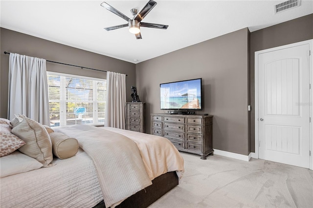 bedroom with ceiling fan and light carpet