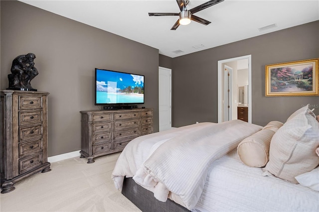 carpeted bedroom with connected bathroom and ceiling fan