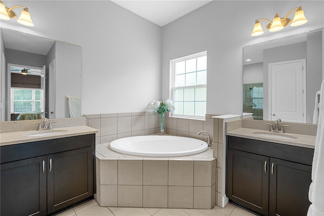 bathroom featuring tile patterned flooring, vanity, and a healthy amount of sunlight