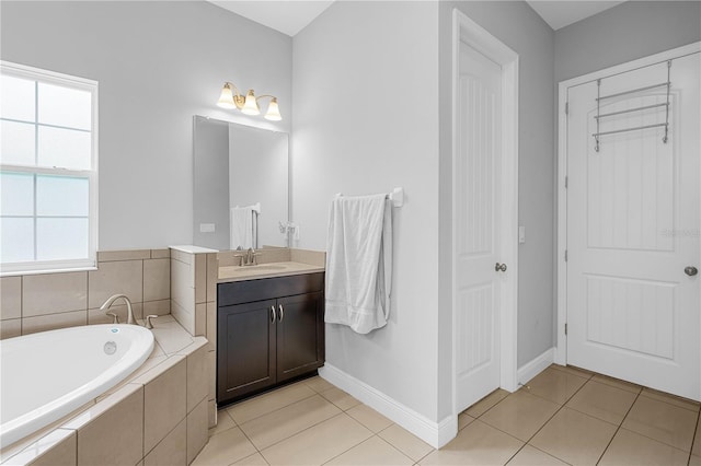 bathroom featuring vanity, tile patterned floors, and tiled tub