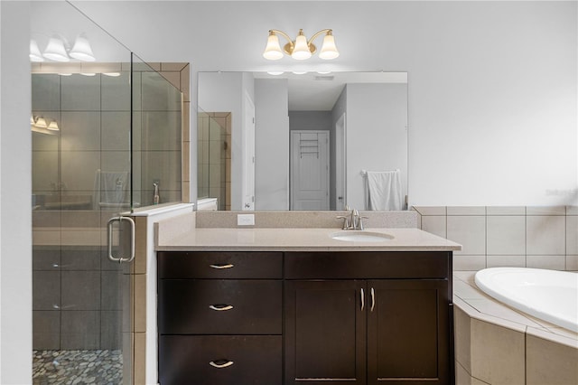 bathroom featuring vanity and separate shower and tub