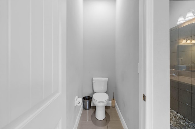 bathroom with tile patterned flooring, a shower, and toilet