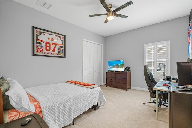 bedroom with light carpet, a closet, and ceiling fan