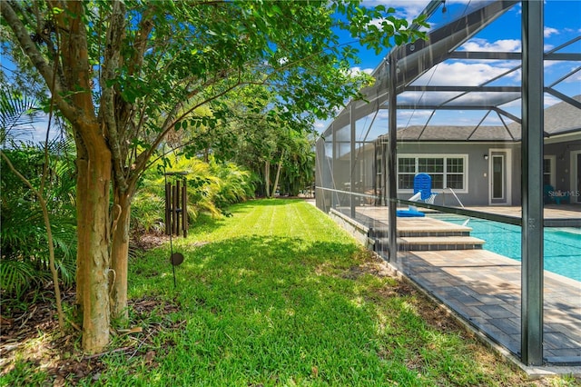 view of yard featuring a patio and glass enclosure