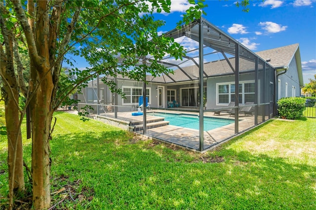 rear view of property with a patio area, a lanai, and a yard