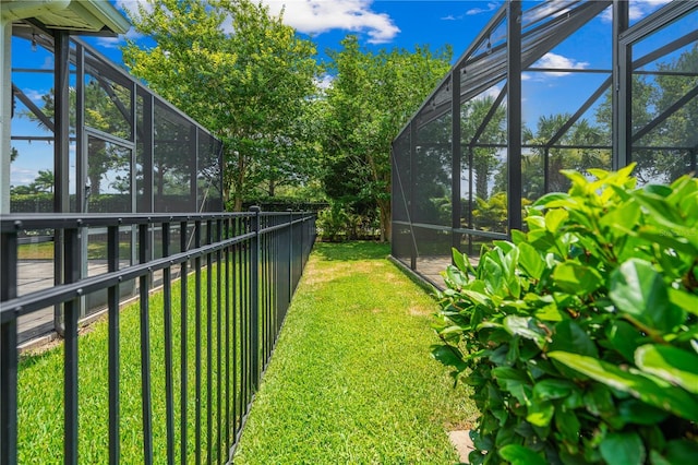 view of yard featuring glass enclosure