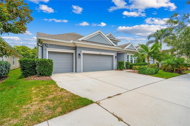 view of front of home with a front yard and a garage