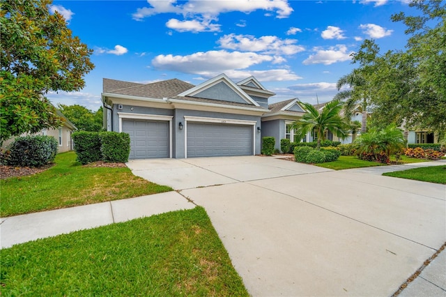 view of front of home with a front yard and a garage