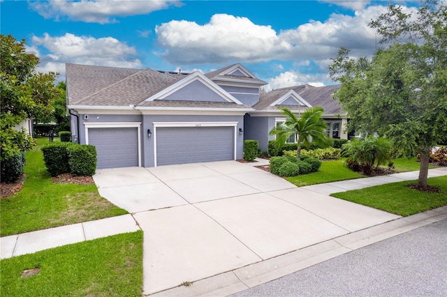 craftsman house featuring a garage and a front lawn