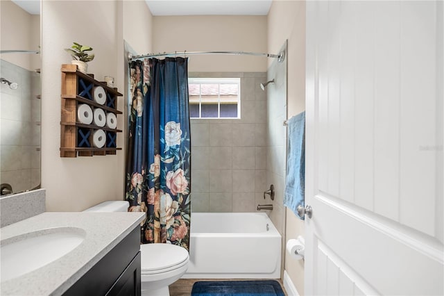 full bathroom with vanity, shower / tub combo, and toilet