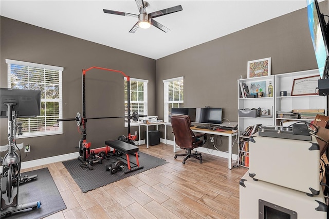 workout area featuring a wealth of natural light, ceiling fan, and light wood-type flooring