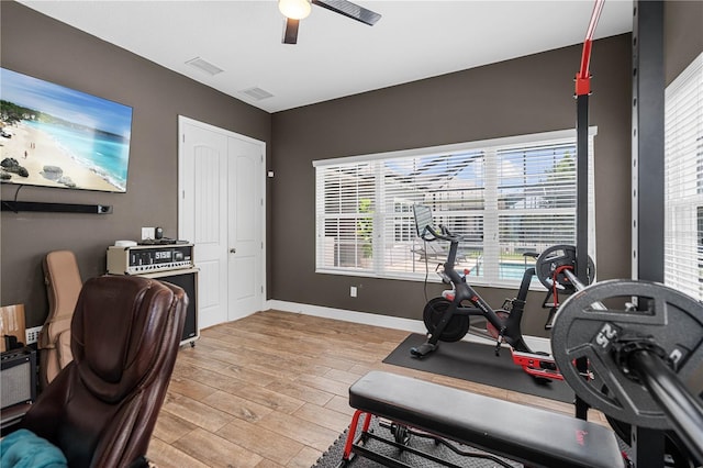 exercise area featuring ceiling fan and light wood-type flooring