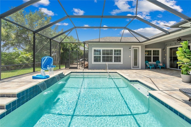 view of swimming pool with a lanai, pool water feature, ceiling fan, and a patio