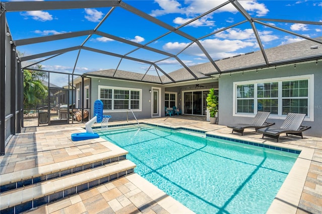 view of pool with a patio, ceiling fan, and a lanai