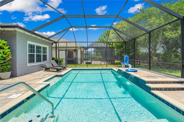 view of pool featuring pool water feature, a patio area, and a lanai