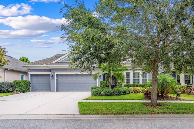 view of property hidden behind natural elements featuring a garage