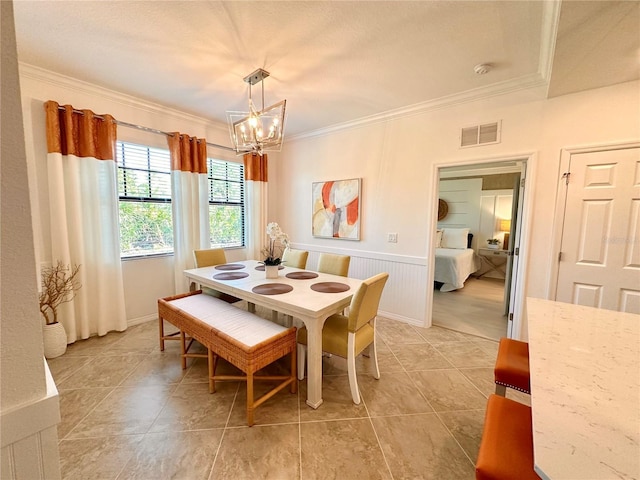 dining area featuring a chandelier and ornamental molding