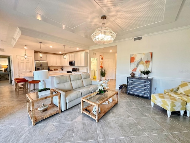 living room with tile patterned flooring and a notable chandelier