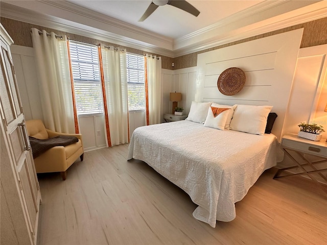 bedroom featuring ceiling fan, light hardwood / wood-style floors, and crown molding