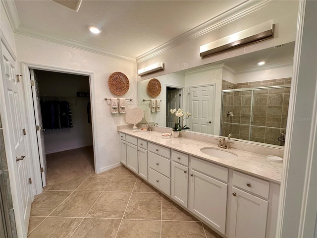 bathroom with tile patterned floors, vanity, a shower with door, and crown molding