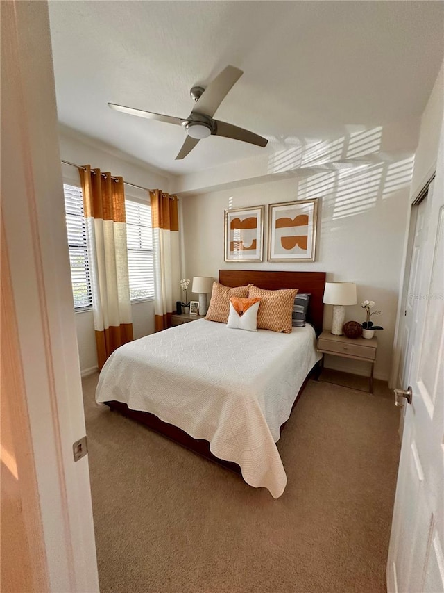 bedroom with carpet, ceiling fan, and a closet