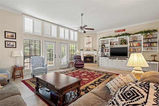 tiled living room featuring ceiling fan and crown molding